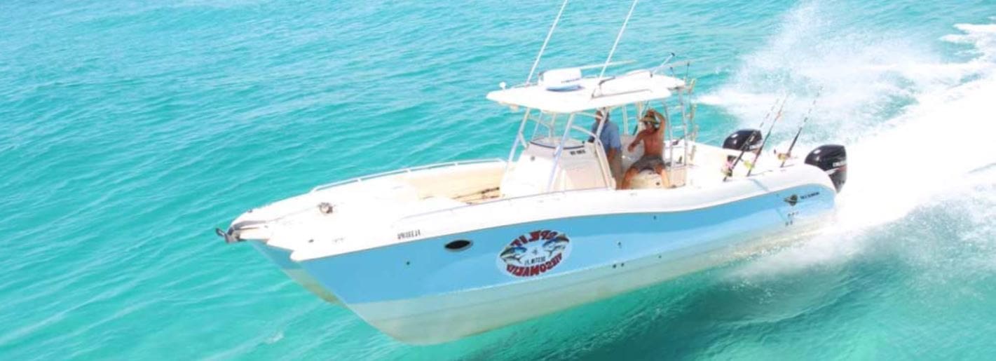 Two people on a World Cat boat in blue water in Destin, Florida