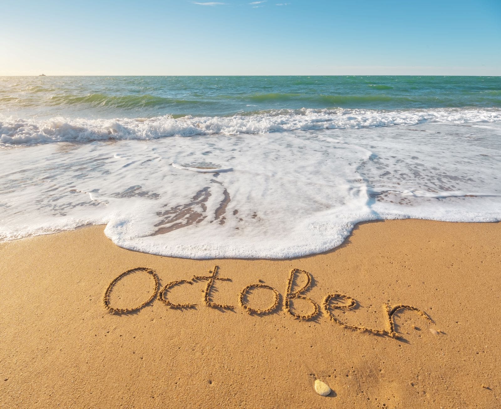 october written out on the beach