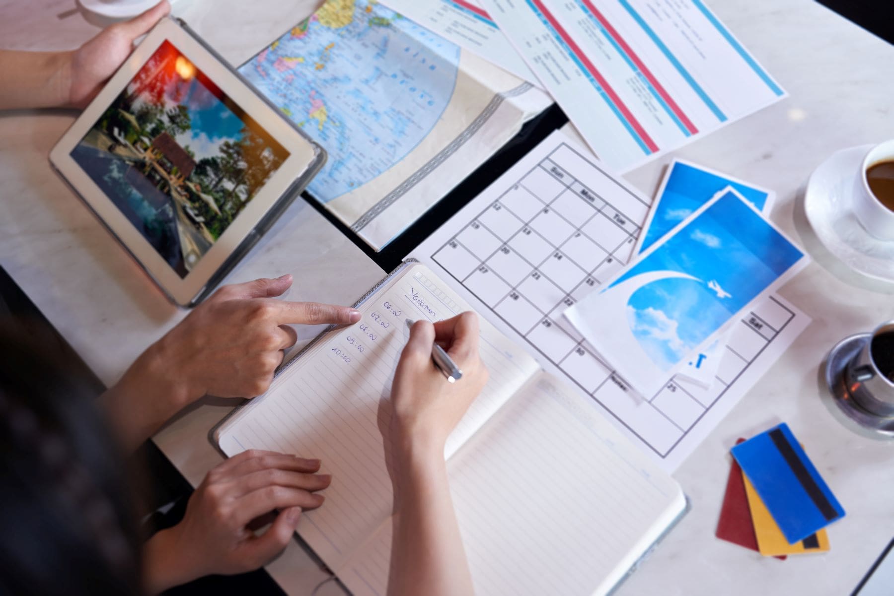 person planning trip in notebook